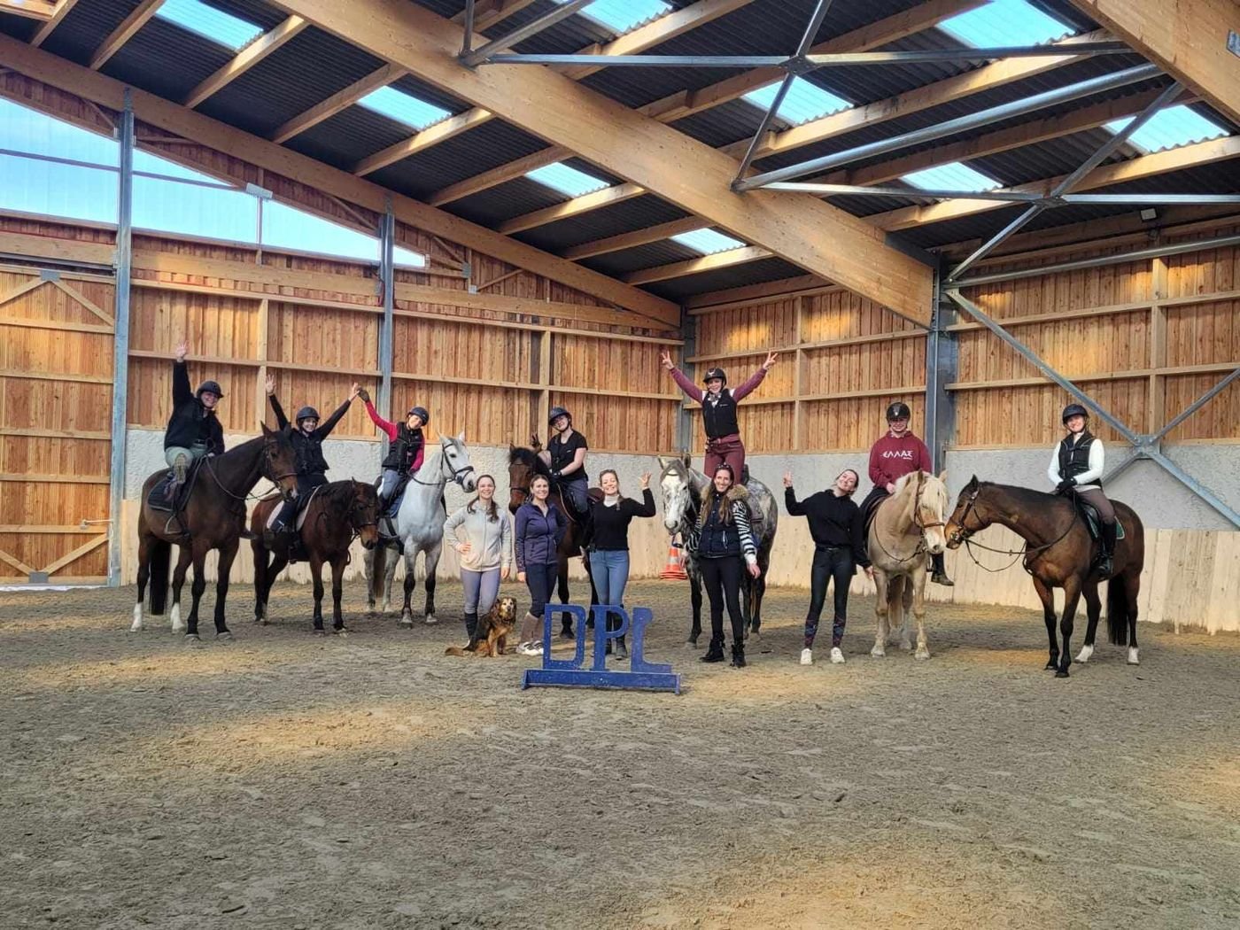 Groupe de cavaliers à cheval réunis en manège autour de Kelly, à la fin d'un stage